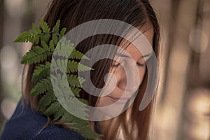 Stylish hipster woman with fern leaf embracing. girl portrait with natural herb, boho sensual bride. romantic moment. rustic eco