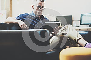 Stylish Hipster working digital tablet modern Interior Design Loft Office.Man work Vintage Sofa electronic device