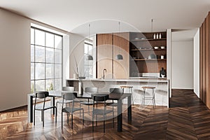Stylish home kitchen interior with dining table, bar counter and window