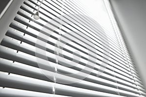 Stylish horizontal window blinds, low angle view