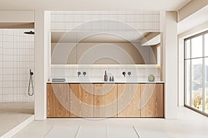 Stylish hotel bathroom interior with double sink and shower, panoramic window