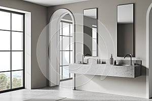 Stylish hotel bathroom interior with double sink and vanity, panoramic window