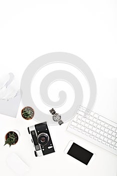 Stylish image workplace, keyboard above isolated on white background. Phone, mouse, envelope with feathers, retro camera
