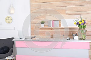 Stylish interior of beauty salon with modern reception desk