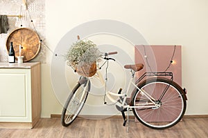 Stylish interior of light spacious room with bicycle. Interior of modern room with big picture and retro bicycle for hipster.