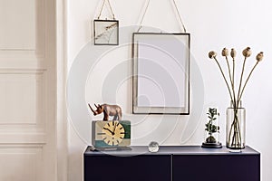 Stylish interior of living room with blue navy commode, mock up poster frame, decoration, book and elegant personal accessories.