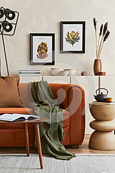 Stylish interior of modern living room with two mock up poster frame, retro design sofa, black lamp and creative personal.