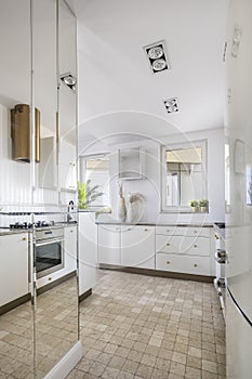 Stylish interior of open space white kitchen