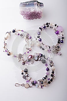 Stylish jewelry bracelets with semiprecious and crystal at white background. hobby and fashion concept photo