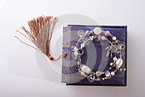 Stylish jewelry semiprecious bracelet  with present box around white background. hobby and fashion concept photo