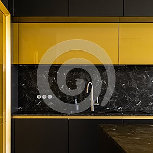 Stylish kitchen in black and gold, close-up