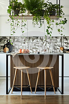 Stylish kitchen interior design with dining space. Workspace with kitchen accessories on the back ground. Creative walls.