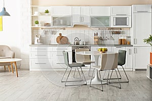 Stylish kitchen interior with dining table photo