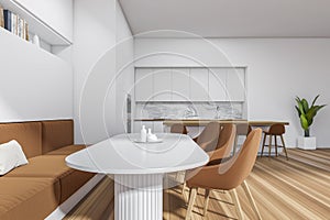 Stylish kitchen interior with eating table and seats, island with bar chairs