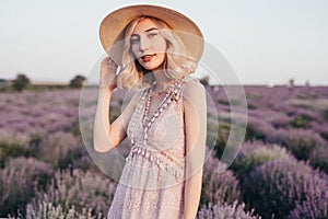 Stylish lady resting in blooming field