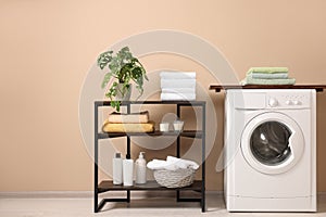 Stylish laundry room with modern washing machine. Interior design