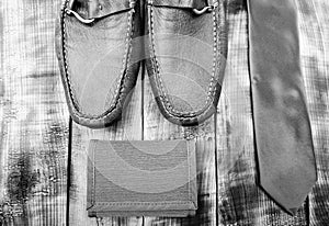 Stylish leather shoes on wooden background. Groom ready for wedding. Menswear and accessories. Matching wallet and