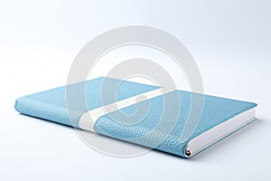 Stylish light blue notebook isolated on white