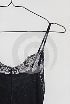 Stylish lingerie. Black nightie hanging on a hanger. Set of female underwear. Advertise or sale concept