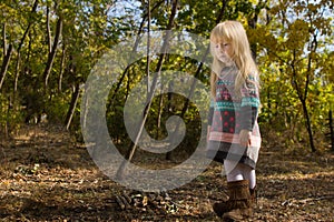 Stylish little blond girl in autumn fashion