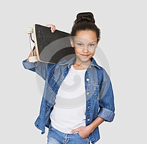 Stylish little child girl with skateboard over white background. Holidays, vacations, summer fun, resting, leisure, people concept