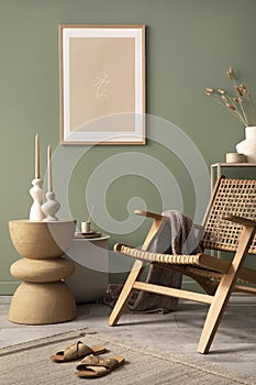 Stylish living room interior design with mock up poster frames, rattan armchair, coffe table, beige carpet and creative home