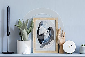 Stylish living room interior at elegant apartment with mock up frame, white clock, candle, gray wood panelling.