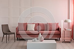 Stylish living room interior with pastel pink velvet sofa photo