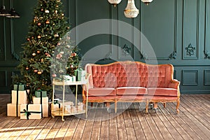 Stylish loft living room interior with decorated Christmas tree, decorative trolley with gifts and pink sofa.