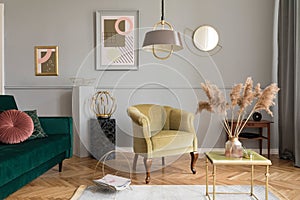Stylish and luxury living room interior with elegant green velvet armchair, sofa, coffee table, marble stands, design lamp.
