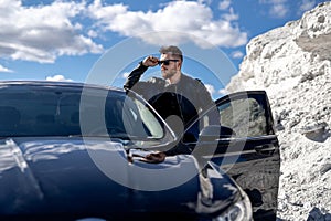 Stylish male model with car. Handsome cool guy in casual cloth.