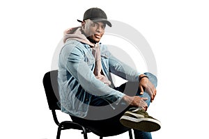 Stylish male model sitting on the chair in the studio