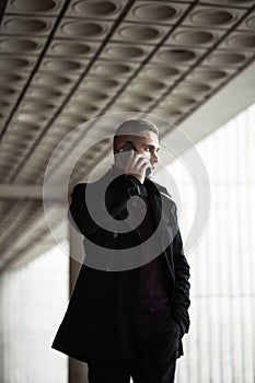 Stylish man in black trenchcoat