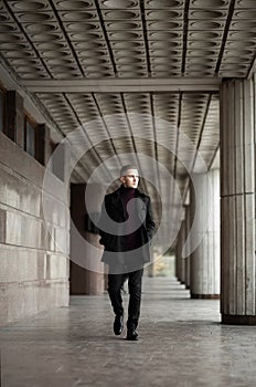 Stylish man in black trenchcoat