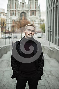 Stylish man in black trenchcoat