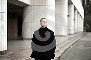 Stylish man in black trenchcoat