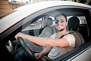 Stylish man driving car