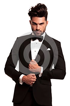 Stylish man in elegant black suit and bowtie