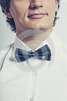 Stylish man in elegant black tuxedo, bow tie