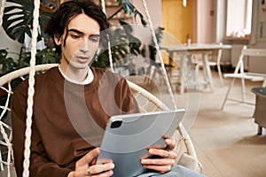 Stylish man exploring pottery techniques in