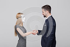 Stylish man handshake with blonde woman in mask