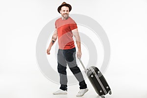 Stylish man in hat carrying suitcase