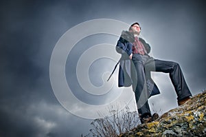 Stylish man over sky background