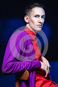 Stylish man in red shirt in dark studio