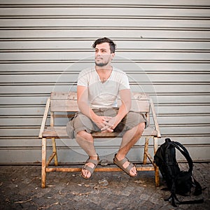 Stylish man sitting on a bench