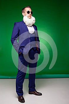 Stylish man in suit with flowers in beard