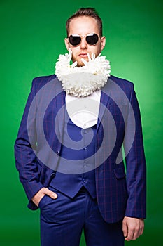 Stylish man in suit with flowers in beard