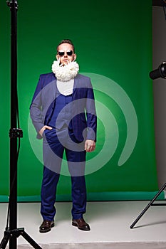 Stylish man in suit with flowers in beard