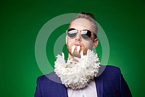 Stylish man in suit and with flowers on neck