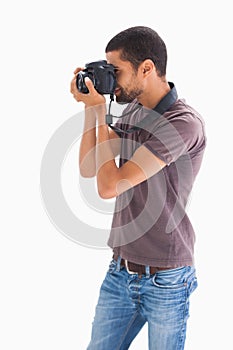 Stylish man taking photograph with digital camera